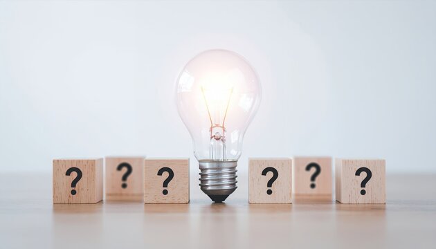 Illuminated light bulb surrounded by question mark blocks, symbolizing problem-solving and new ideas.