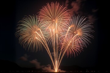Vibrant fireworks explode in sky, golden and red bursts illuminate night, creating dazzling spectacle of celebration.