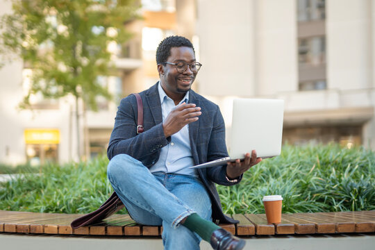 African man having virtual meeting on laptop in city