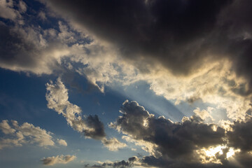 Sunset in the city with clouds and rays of light on the sky