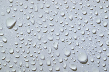 Water droplets on a smooth surface create a clear sparkling effect in soft light