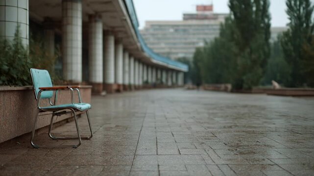 Solitude blue chair on wet stone surface architecture background