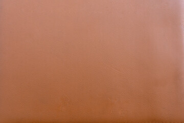 A close up texture image of rich brown tanned leather material surface background