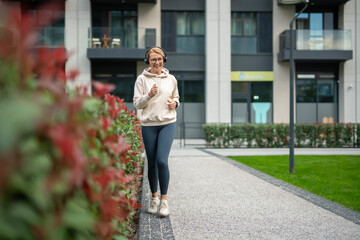 Mature woman jogging outdoors enjoying active lifestyle