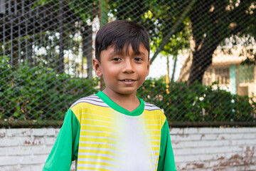 Portrait of a young Hispanic soccer player smiling and looking at the camera inside a sports club in Neiva, Huila, Colombia. Concept of childhood and happiness