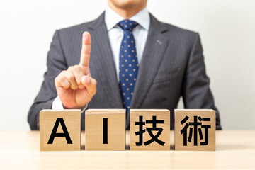 「AI技術 」と書かれたブロックとビジネスマン