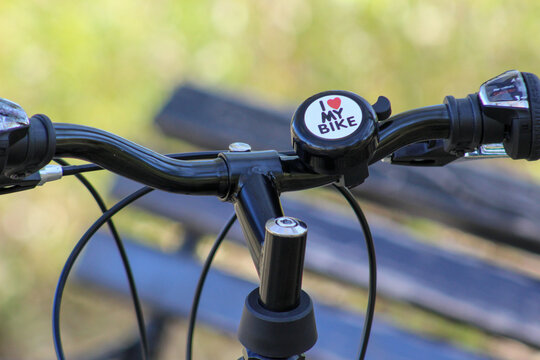 Detail shot of a bicycle bell featuring a heart and “I MY BIKE” text, representing love for biking and healthy outdoor living.