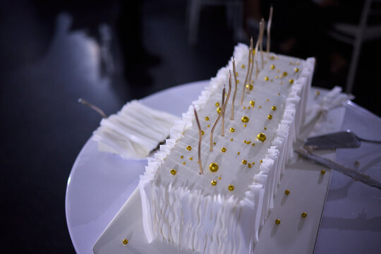Couple shares wedding cake, Bride and groom enjoy their special cake moment together, Bride and groom cheerfully cut their elegant wedding cake amid joy and celebration