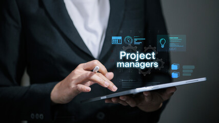 Project manager using digital tablet with virtual project management dashboard