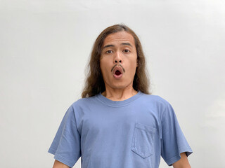 long haired man with a surprised expression