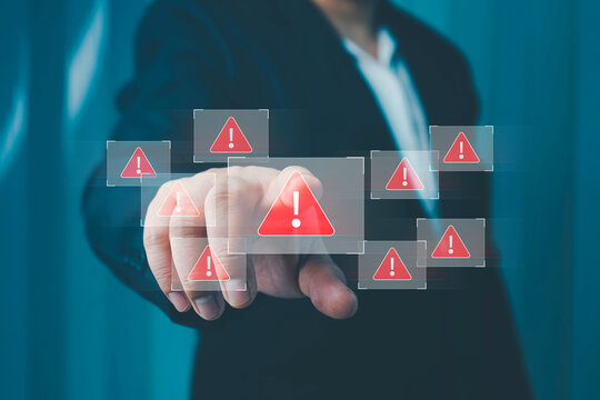System warning alert on a virtual interface with hand interaction, illustrating cybersecurity risks, data breaches, malware threats, hacking, and digital system vulnerabilities. - Powered by Adobe