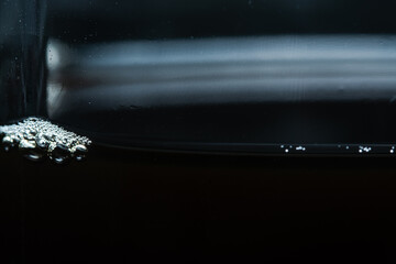 Detailed texture of freshly brewed coffee showing fine micro-bubbles on the surface.