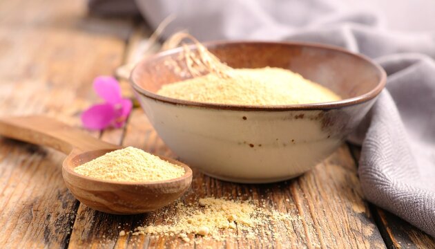 Bowl of semolina on wooden table. - Powered by Adobe