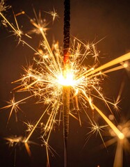 Close-up of a lit firework, emitting sparkling trails against a dark background, creating a dazzling display of light