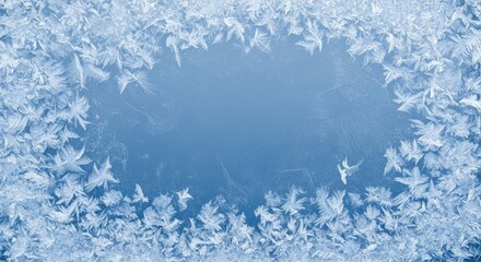 A frosty window with intricate ice patterns on a blue background.