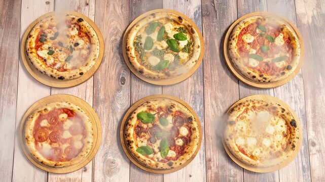 窯焼きの香りが立ちのぼる石窯ナポリピザを並べた美味しさ溢れる本格イタリアンの光景