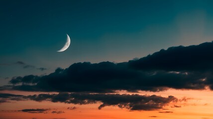 Crescent moon glowing in a dramatic twilight sky with dark clouds and vibrant orange and blue hues