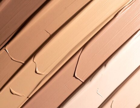 Diagonal swatches of foundation makeup showing a range of skin tones, textures vary subtly, highlighting cosmetic options