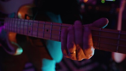 Musician plays guitar in vibrant band setting with lively atmosphere