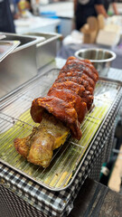 close-up of traditional Balinese roasted pork with crispy golden skin at a street food market. a rich Indonesian dish. crispy pork belly ready to serve. pork food festival. Indonesian babi guling