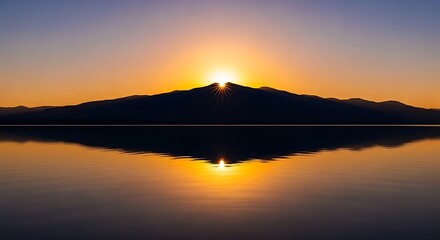 Fototapeta premium Golden sunrise illuminates a majestic mountain peak, creating a breathtaking silhouette mirrored perfectly in the tranquil waters below, a serene natural landscape scene evoking peace and beauty
