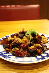 Sichuan cuisine (Chinese cuisine): fried chicken and chili peppers with coriander