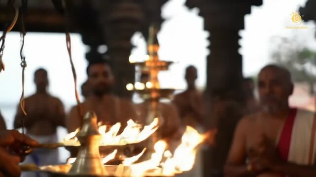 Indian Hindu ceremony, men holding lit oil lamps during ritual inside a temple, symbolic