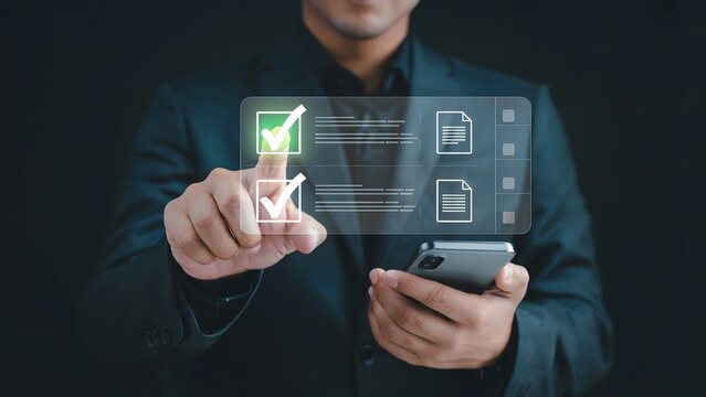 A businessman in a dark suit interacting with a glowing digital interface showing a green checkmark and task icons while holding a smartphone