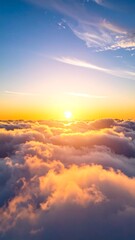 Fototapeta premium Aerial view of a radiant sunrise over a sea of fluffy clouds, transitioning into a bright blue sky