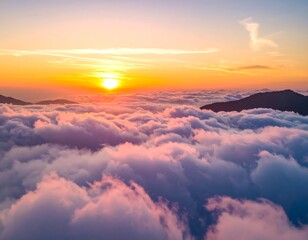 Aerial view of a stunning sunset. The sun's golden rays paint the clouds with hues of pink and orange. Mountains peak through the fluffy formations