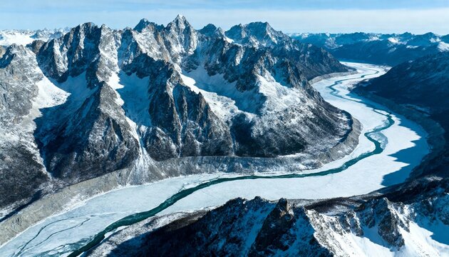 Aerial View of Winding Frozen River Through Snow-Capped Mountains - Powered by Adobe