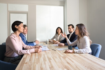 Smart young businesswoman share idea with diverse multiethnic professional team