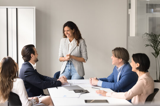Young woman business trainer involve colleague in discussion on briefing