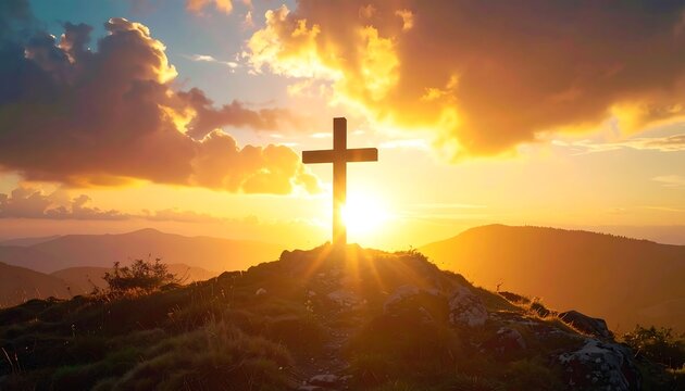 Silhouette of a cross on a hill against a vibrant sunset