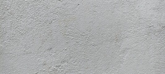 Rough White Plaster Wall Texture Background. Close-up of rough white plaster wall texture, showing natural grain, imperfections, and subtle surface variations