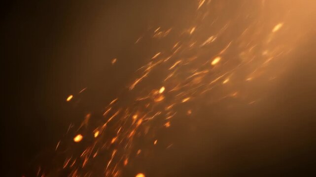 Abstract orange sparks fly upwards against dark background usable for motion graphics.