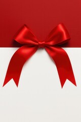 Red satin bow on white and red holiday background
