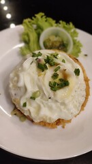 A close up picture of Fried Rice with Egg and salad in a white plate