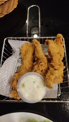 A close up picture of chicken tender with mayonnaise sauce
