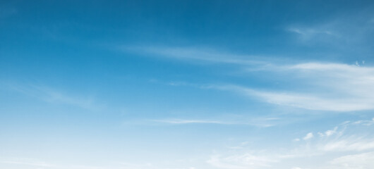 the sky is full of white clouds, bright blue, and beautiful sunlight.