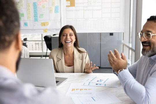 Positive diverse business team brainstorming on project in meeting room