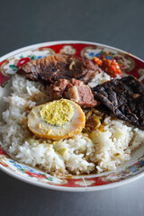 Madura Mixed Rice, captured on November 16, 2025. Steamed rice served with seasoned meats, sambal, eggs, and assorted side dishes, rich and flavorful Indonesian traditional food visuals