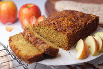 Apple cinnamon bread. Freshly baked loaf with slices cut, showing moist interior and golden crust