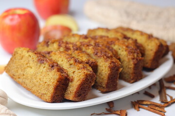 Apple cinnamon bread. Freshly baked loaf with slices cut, showing moist interior and golden crust