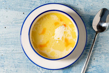Creamy seafood soup with shrimp and spices served in white bowl