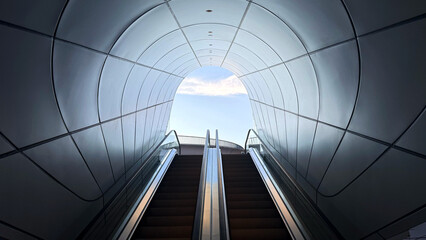 Modern escalator leading to the sky through a futuristic architectural tunnel