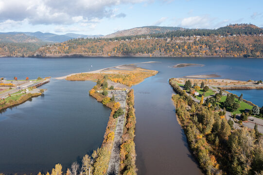 Aerial drone view of Columbia River near Hood River, Oregon, USA in late fall. Scenic landscape with calm blue water, forested hills, and clouds over the Pacific Northwest, ideal for travel usage