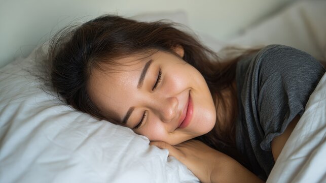 Smiling woman asleep in cozy bed with soft pillows, enjoying peaceful rest - Powered by Adobe