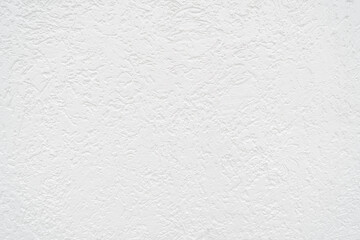 The wall finish in the image is called decorative textured plaster. This is a general term for a wide range of finishes that impart a three-dimensional texture to a surface.