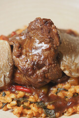 Savory beef dish with vegetables and grains on a plate